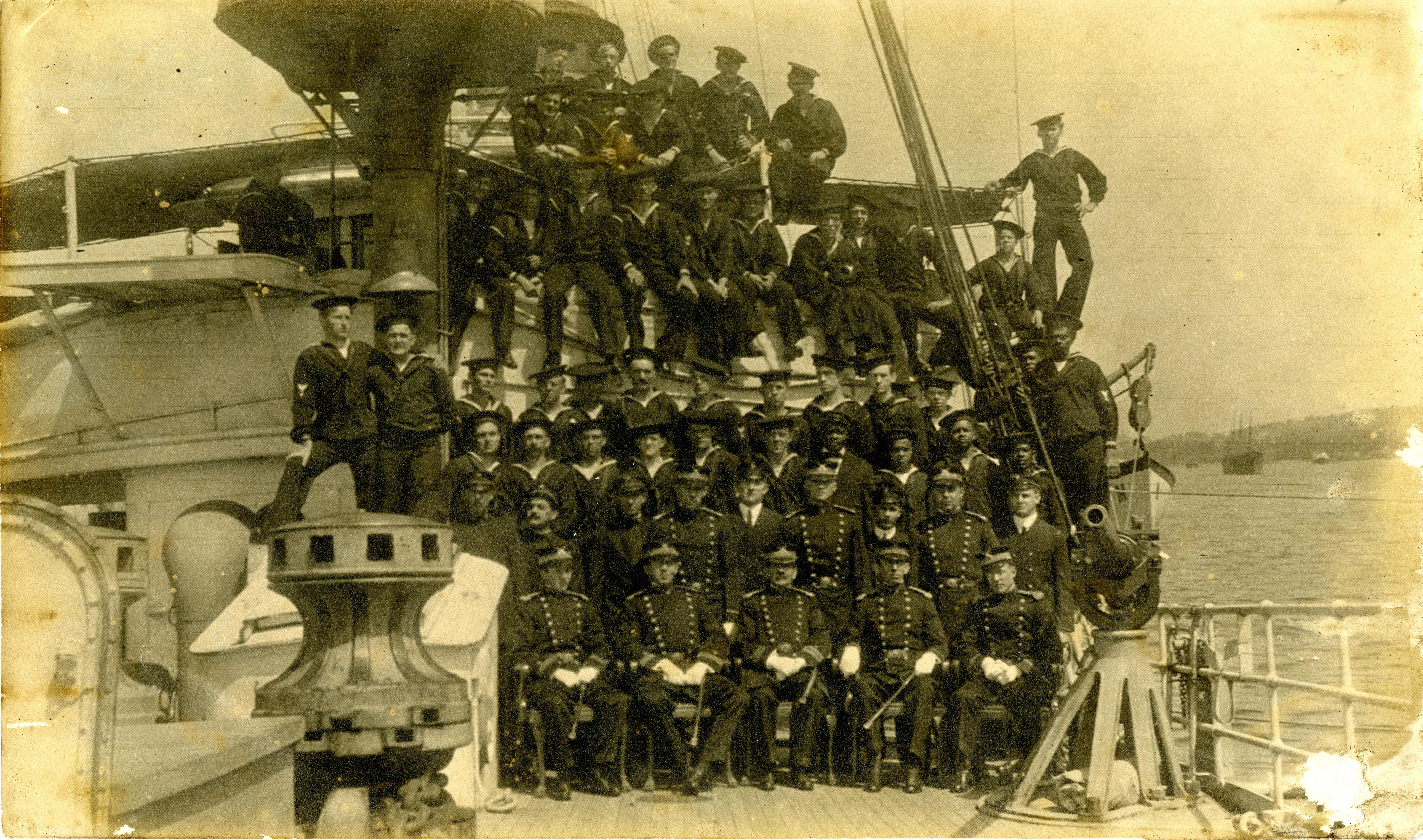 2.	Faded image of Tampa’s crew in 1913, showing officers in the bottom two rows and minority crew members the next level up on the right side. By 1918, many of these men had transferred or gone ashore. (U.S. Coast Guard)